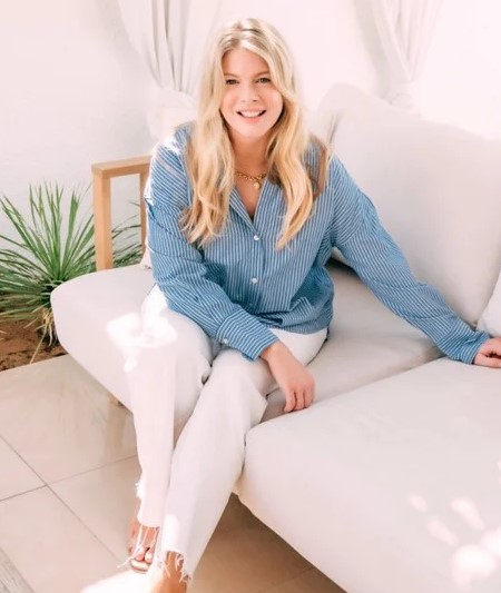Beth Clay, founder of Financed Well, seated and smiling